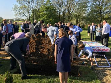 backfilling grave by hand