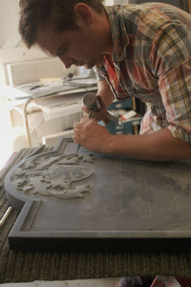 Fergus Wessel carving a headstone