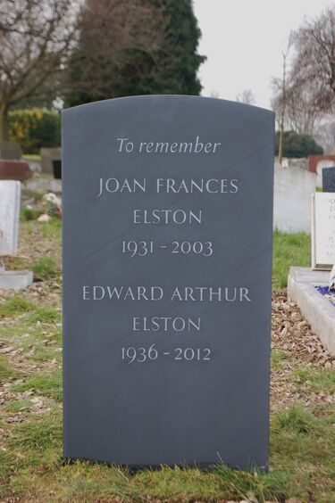 hand carved slate headstone with gilded disc