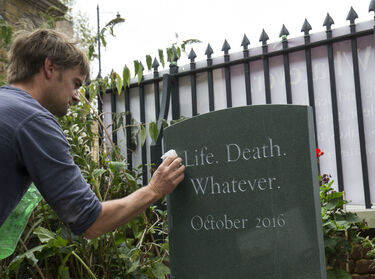 cleaning headstone at Sutton House