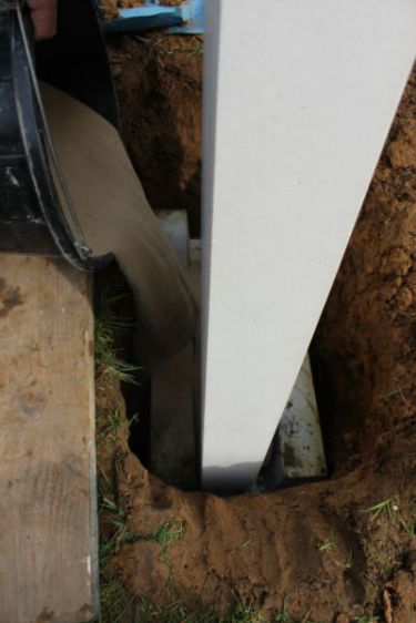 pouring sand around concrete shoe