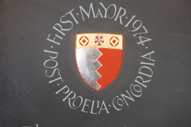 crest carved in slate headstone