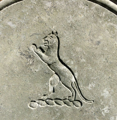 symbol lion on headstone in relief