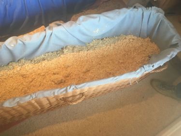 wicker coffin with shavings
