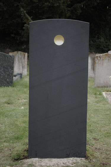 Gold disc on headstone