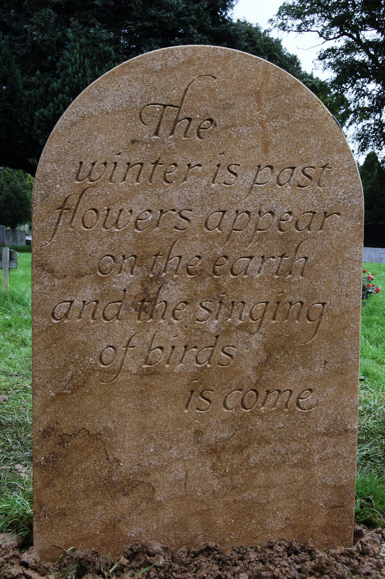 honey coloured hand carved headstone