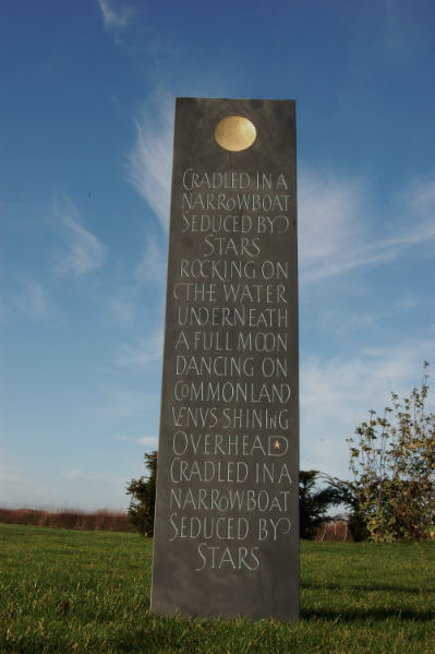 obelisk in the garden with lettering
