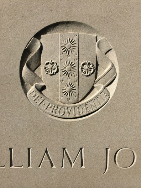 crest on limestone headstone