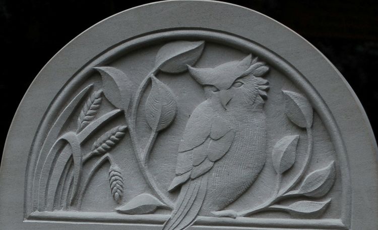 relief carving of owl on portland headstone