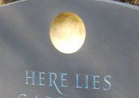 Golden disc on headstone